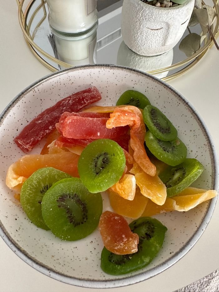 A vibrant bowl of assorted dried fruits including sliced kiwi, perfect for a healthy snack.