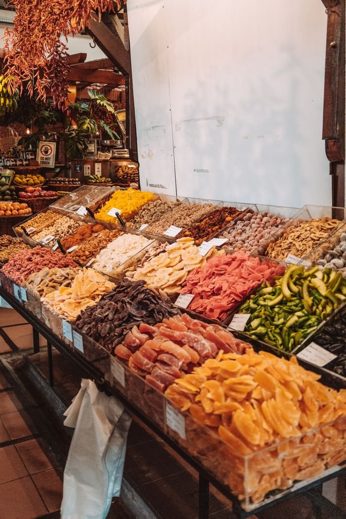 Vibrant array of dried fruits at a local market in Madeira, Portugal.