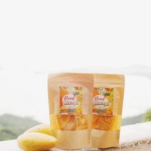 Tropical scenery showcasing packaged dried mangoes and fresh mangoes.